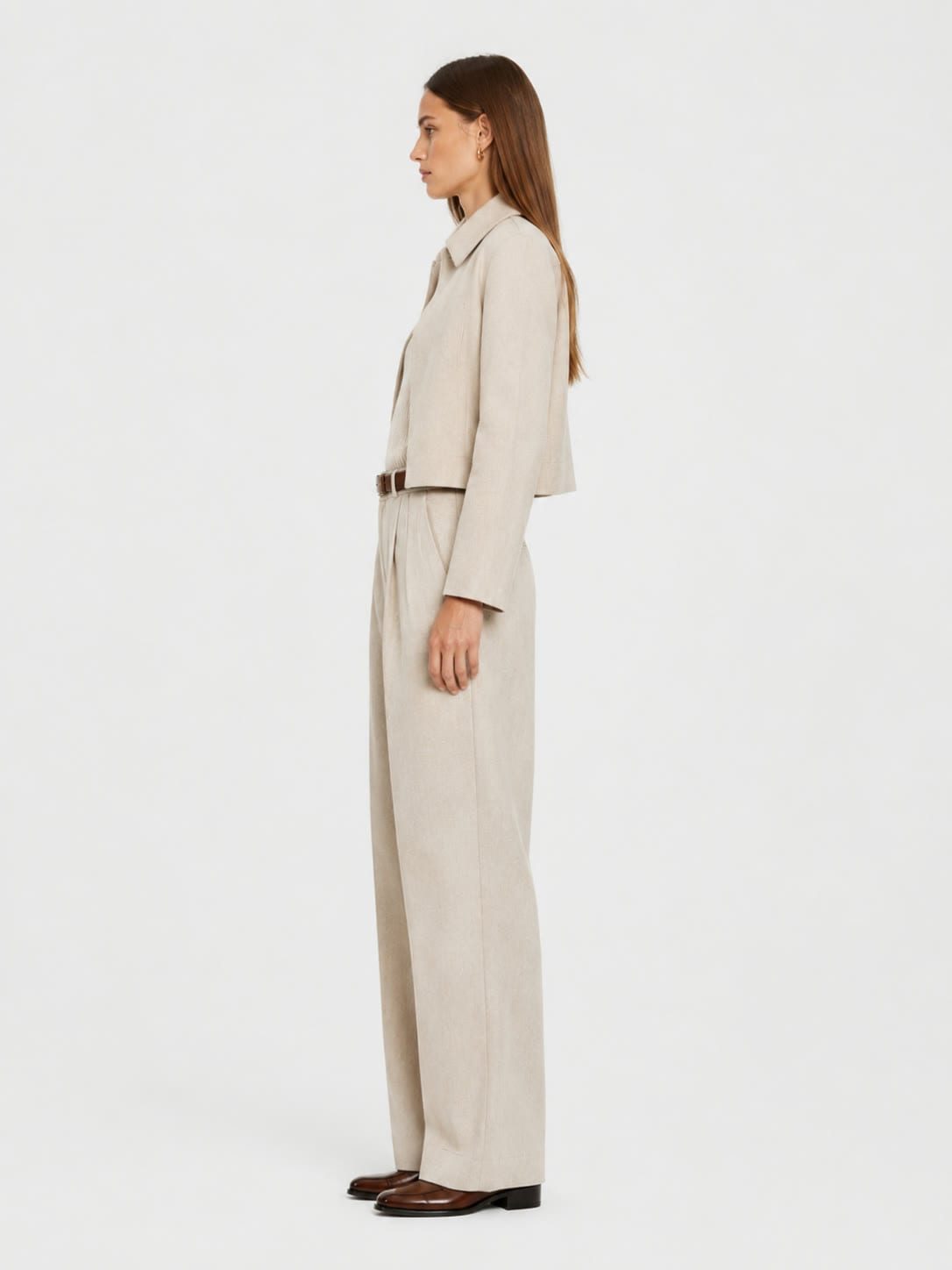 The Pleated Trouser worn with a soft shirt, studio view